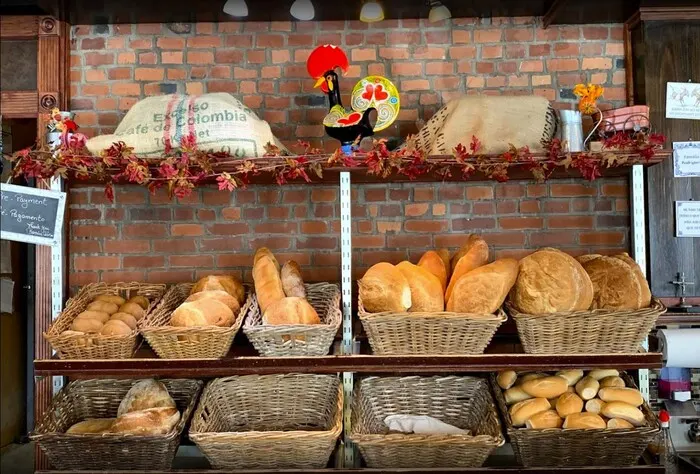 Baskets of bread on a brick wall with a Barcelos rooster