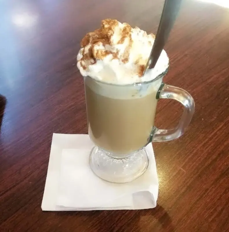 A latte served in a glass mug