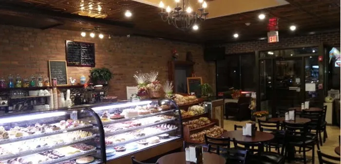 The bakery interior with pastry cases and café tables