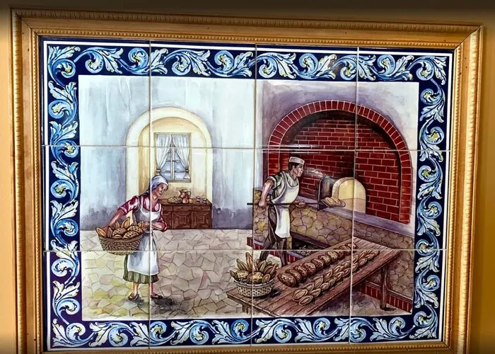Azulejo tile mural of a baker at a brick oven